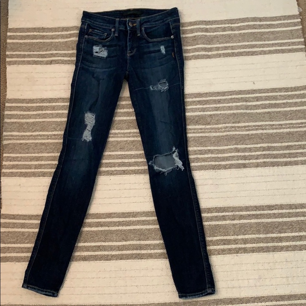 denim jeans with holes in leg.